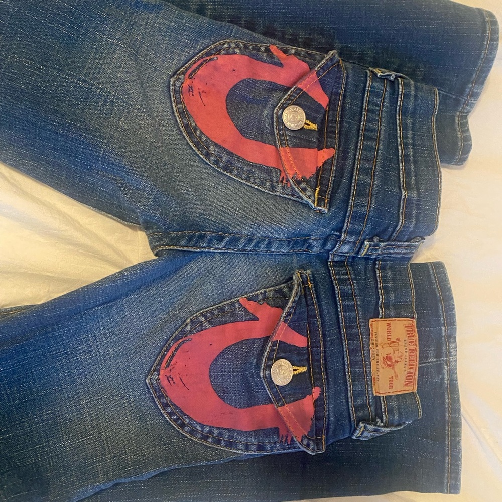 true religion flare jeans with pink detailing!